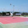 Un campo da tennis con persone che giocano.