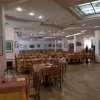 Ampia sala ristorante con tavoli apparecchiati.