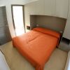 Camera con letto matrimoniale e armadio beige.