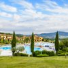 Piscina e giardini curati, case nelle colline al tramonto.
