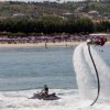 Uomo su una tavola a getto d'acqua in mare.