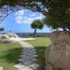 Giardino con arco di piante e sentiero verso il mare.