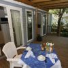 Tavolo su veranda coperta, vista cucina interna.