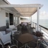 Veranda sul mare con tavoli e sedie.