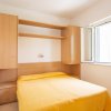 Stanza da letto con letto matrimoniale e finestra aperta, arredo in legno.